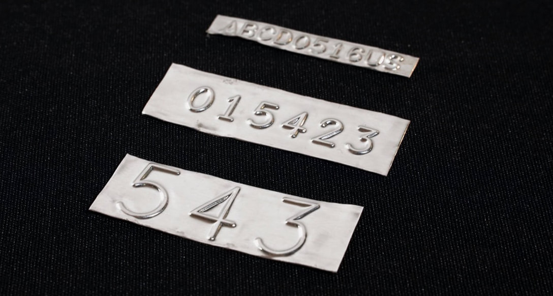 embossed pattern labels for date codes, heat numbers, order numbers